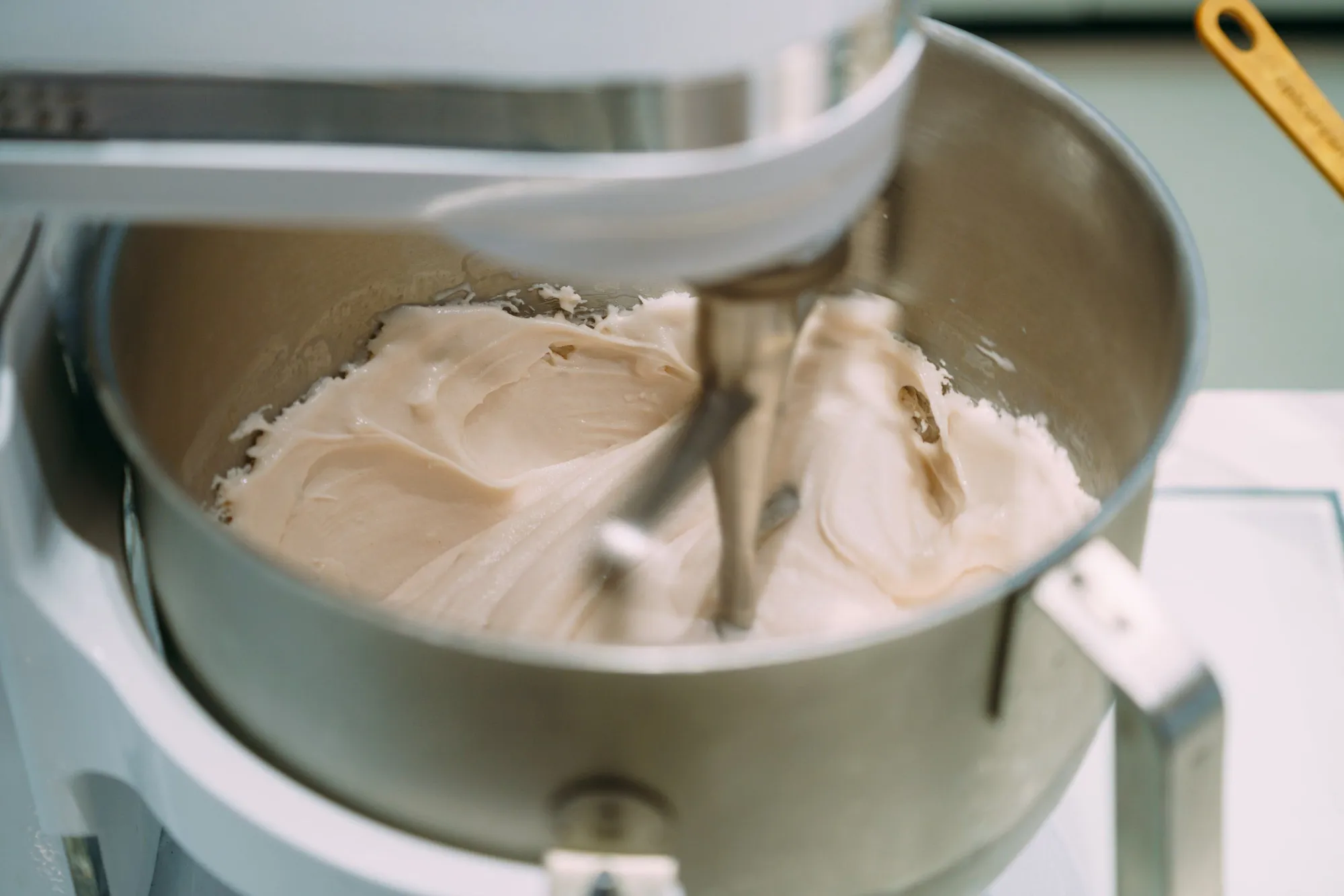 Gelato thickening in a steel mixer bowl as the paddle turns